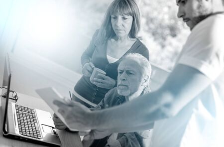 Business people working together in office, light effect; multiple exposureの写真素材