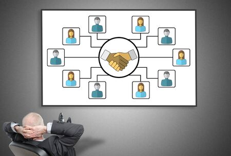 Relaxed businessman looking at collaboration concept on a whiteboardの写真素材