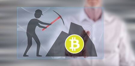 Man touching a bitcoin mining concept on a touch screen with his finger