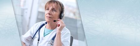 Portrait of mature female doctor during online medical consultation; panoramic bannerの写真素材