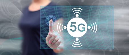 Woman touching a 5g concept on a touch screen with her fingerの写真素材