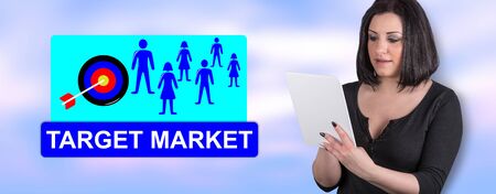 Woman using digital tablet with target market concept on backgroundの写真素材
