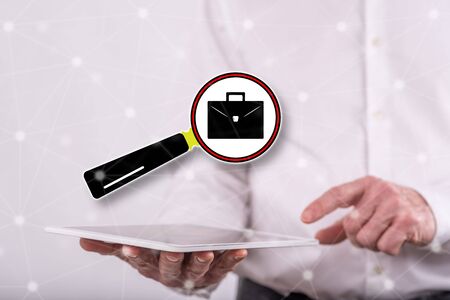 Job search concept above a tablet held by a man in backgroundの写真素材