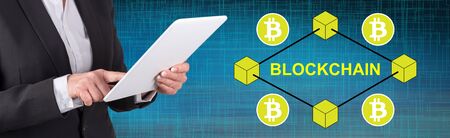 Woman using digital tablet with blockchain concept on background