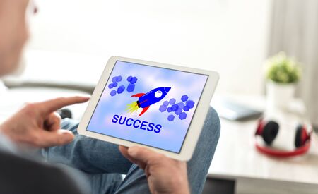 Tablet screen displaying a success conceptの写真素材