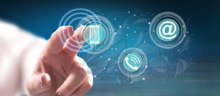 Woman touching a contact concept on a touch screen with her finger