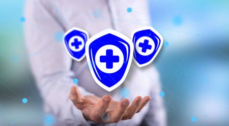 Health protection concept above the hand of a man in backgroundの写真素材