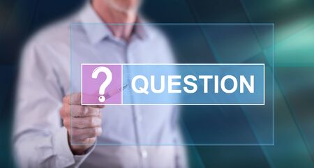 Man touching a question concept on a touch screen with a penの写真素材