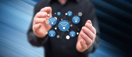 Wireless connection concept between hands of a man in backgroundの写真素材