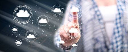 Woman touching a cloud networking concept on a touch screen with her fingerの写真素材