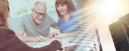 Senior couple meeting financial adviser for investment; multiple exposureの写真素材