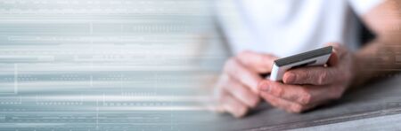 Man sitting using a smartphone; panoramic banner