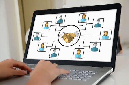 Hands on a laptop with screen showing collaboration concept