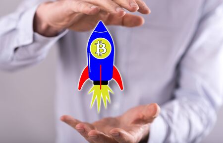 Bitcoin rise concept between hands of a man in background