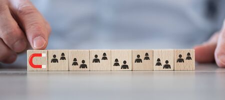 Concept of customer attraction on wooden cubes