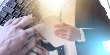 Businessman using tablet, light effect; multiple exposureの写真素材