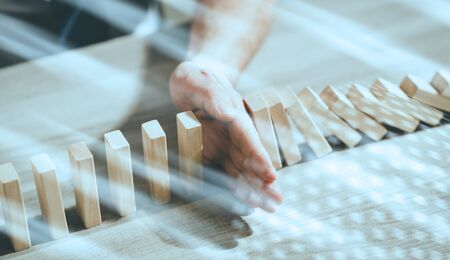 Business control concept by stopping domino effect; light effect