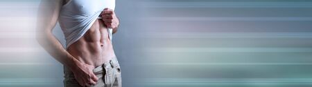 Muscular young man showing abs; panoramic bannerの写真素材