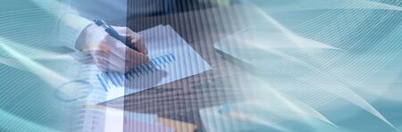 Man working on financial graphs in office, double exposure; panoramic bannerの写真素材