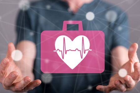 Cardiac emergency concept between hands of a man in backgroundの写真素材