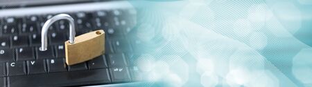 Computer security concept with a padlock on a keyboard; panoramic banner