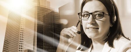Portrait of smiling female phone operator with headset; multiple exposure