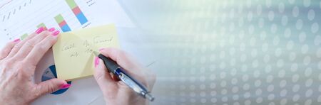 Businesswoman taking notes on a note; panoramic banner