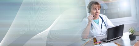Portrait of mature female doctor during online medical consultation; panoramic bannerの写真素材