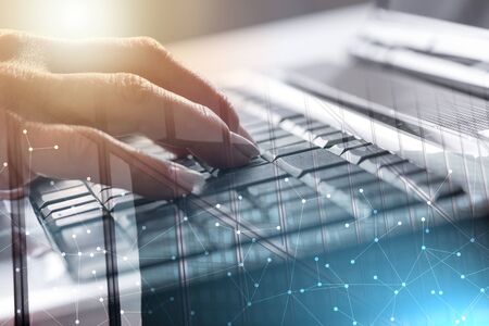 Female hands typing on a laptop keyboard; multiple exposure