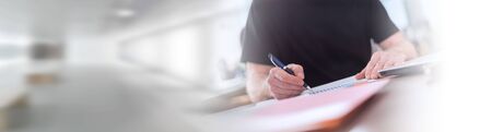 Man sitting and working in office; panoramic bannerの写真素材