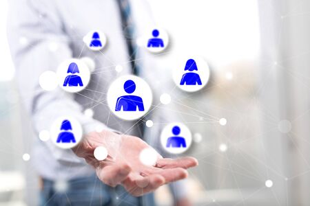 Social network concept above the hand of a man in backgroundの写真素材