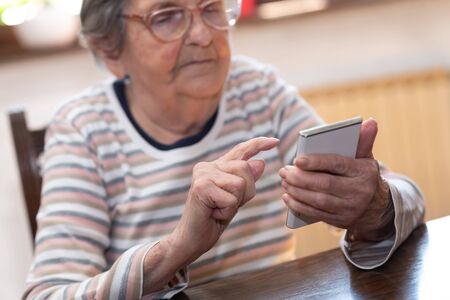 Elderly woman using a mobile phone