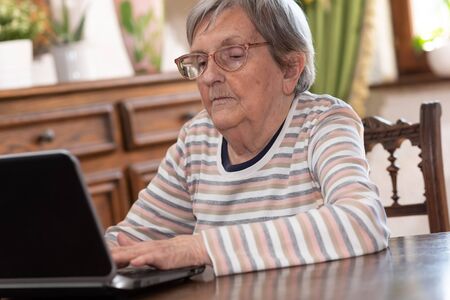 Elderly woman using a laptopの写真素材