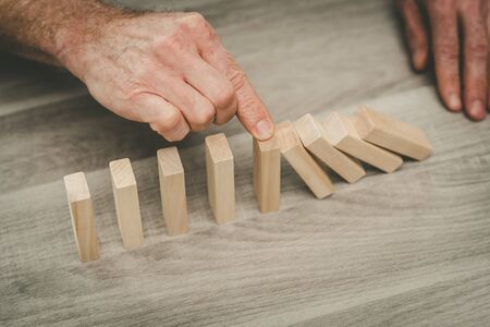 Business control concept by stopping domino effect