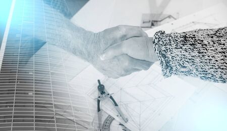 Architect shaking hands with his client; multiple exposureの写真素材
