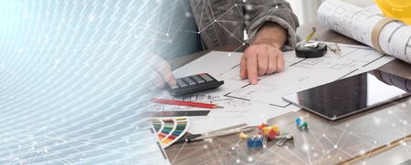 Architect working on plans at office; panoramic bannerの写真素材