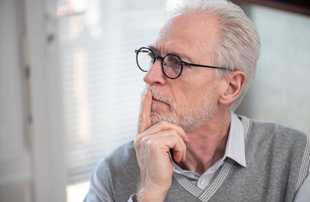 Portrait of pensive senior businessmanの写真素材