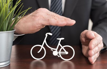 Insurer protecting a bicycle with his hands
