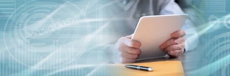 Businessman working on digital tablet, closeup; panoramic banner