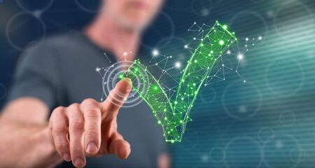 Man touching a validation concept on a touch screen with his finger