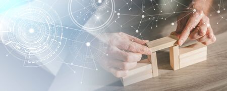 Hands building a wooden block bridge; concept of business association; panoramic banner