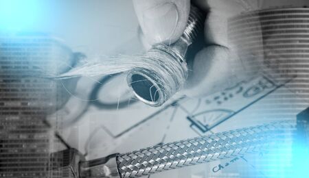 Plumber putting hemp fibers on a thread, closeup; multiple exposureの写真素材