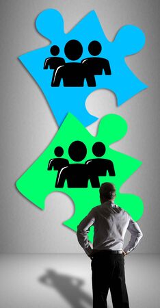 Businessman watching a teamwork concept drawn on a wallの写真素材