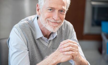 Portrait of smiling senior businessman sitting in office