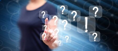 Woman touching a q&a concept on a touch screen with her fingerの写真素材