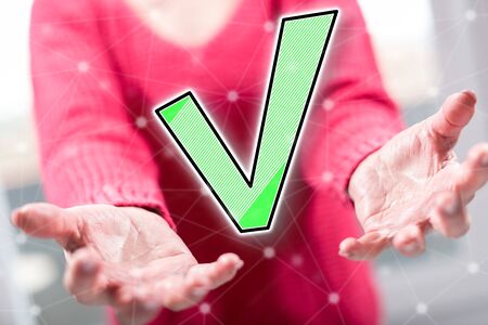 Validation concept above the hands of a woman in backgroundの写真素材