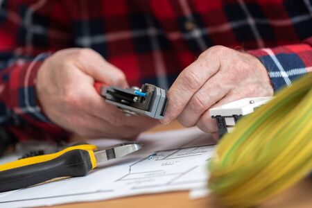 Electrician hands stripping a wireの写真素材