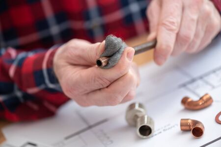 Plumber preparing a copper tube before weldingの写真素材