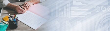 Businessman signing a document in office (lorem ipsum text used; panoramic bannerの写真素材