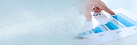 Analyzing growing results on a graphic; panoramic bannerの写真素材